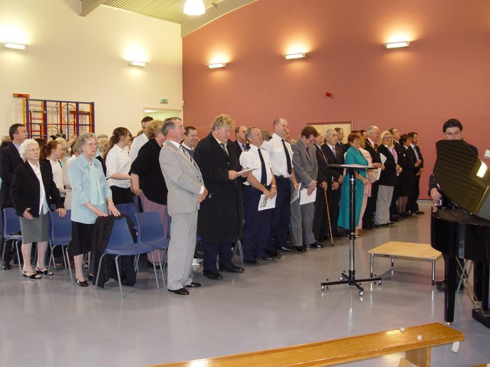 The assembled guests stand in preparation for the official unveiling of the Miners memorial.