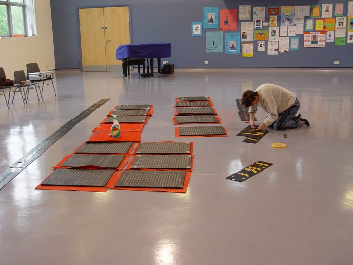 Joanna Daniel prepares the lettering.