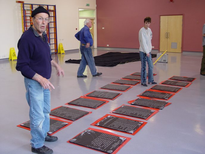 Preparing the plaques. L-R Ken L. James, Trevor John and Joanna Daniel