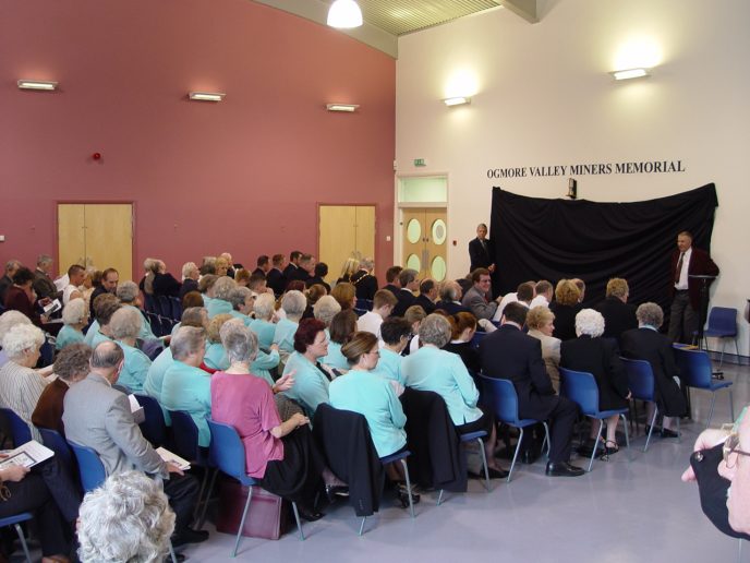 The assembled audience eagerly await the ceremony.