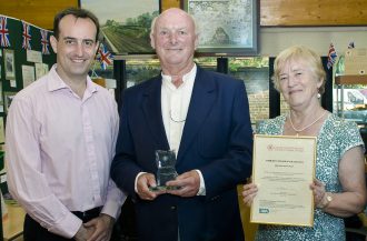 Dr Nick Barratt presenting the Community Archive of the Year Award 2011, in Marden, to David McFarland and Eurice Doswell of the Marden History Group.