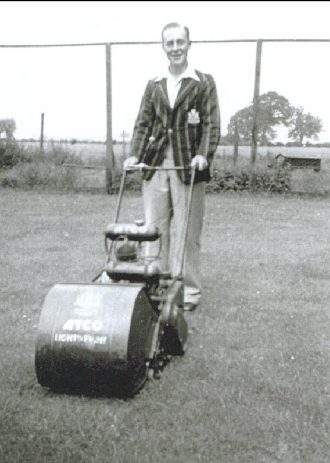 S Smith cutting the grass of the old cricket pitch, 1933