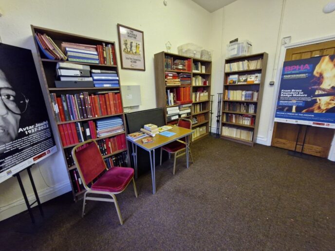 Birmingham People’s History Archive. A room with book cases and chairs. | Image courtesy of Birmingham People’s History Archive